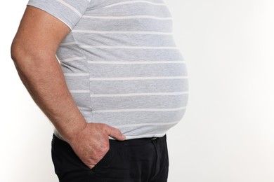 Photo of Overweight man in tight t-shirt on white background, closeup. Space for text