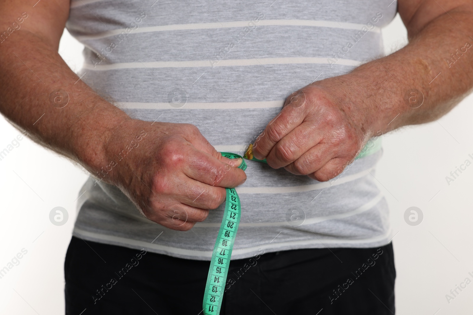 Photo of Overweight man measuring his belly with tape on white background, closeup