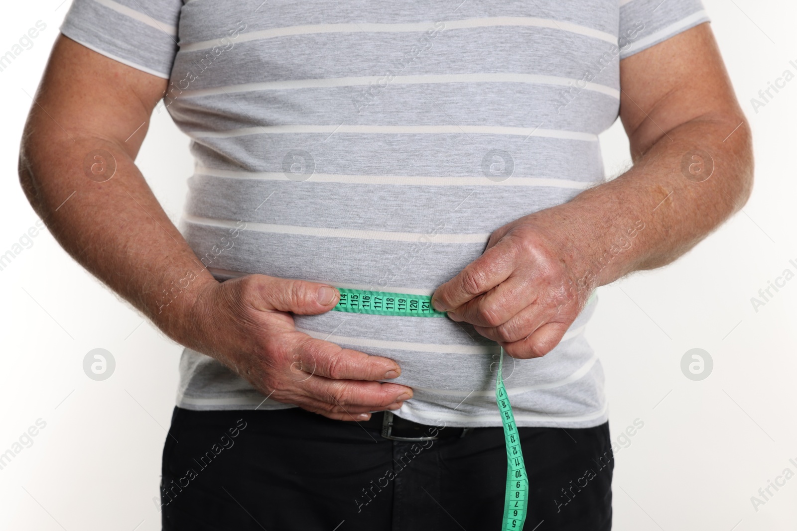 Photo of Overweight man measuring his belly with tape on white background, closeup