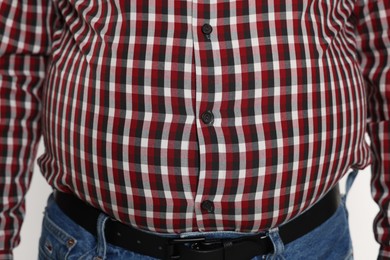 Photo of Overweight man in tight shirt, closeup view