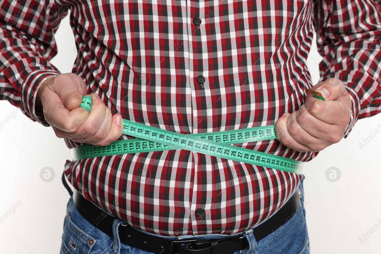 Photo of Overweight man measuring his belly with tape on white background, closeup