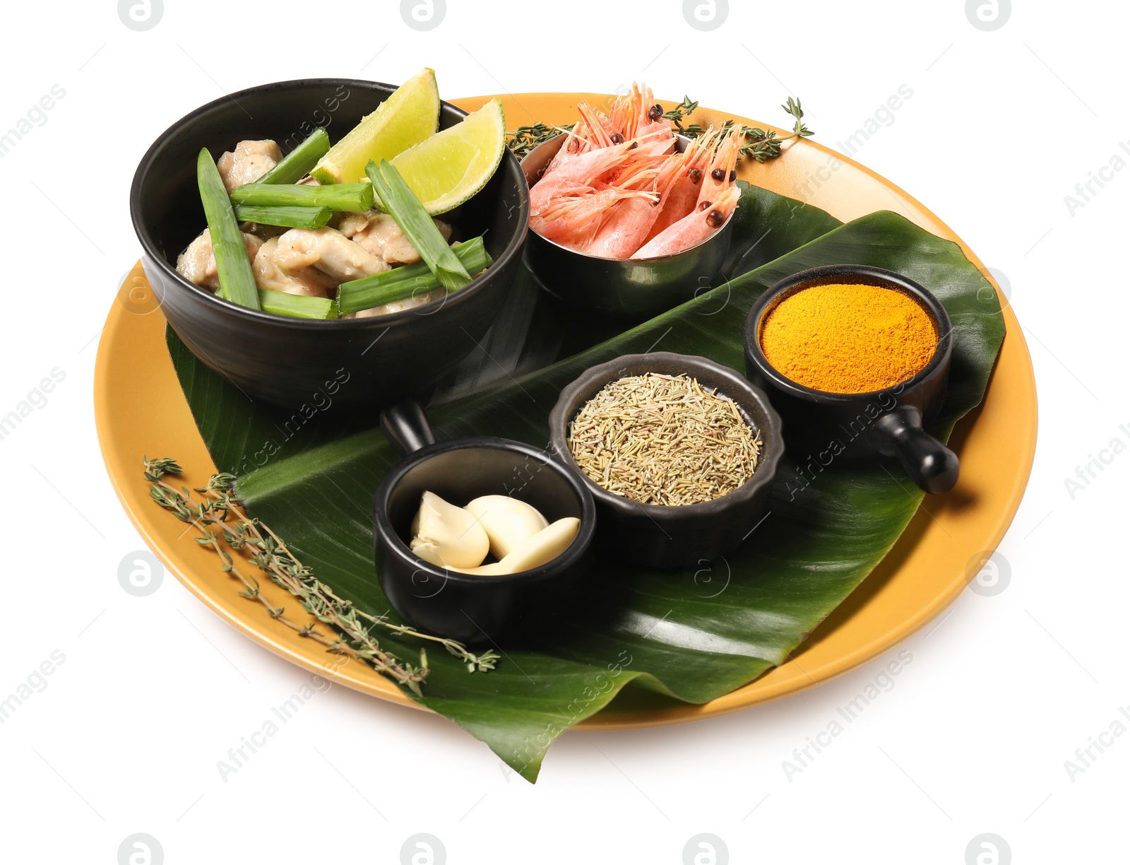 Photo of Cut banana leaf with different food and spices isolated on white. Healthy eco serving