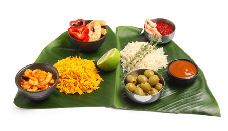 Photo of Cut banana leaf with different food and sauces isolated on white. Healthy eco serving