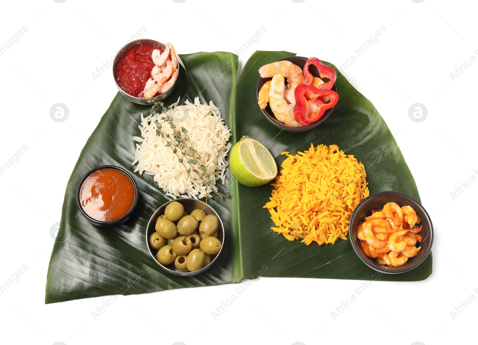 Photo of Cut banana leaf with different food and sauces isolated on white, top view. Healthy eco serving