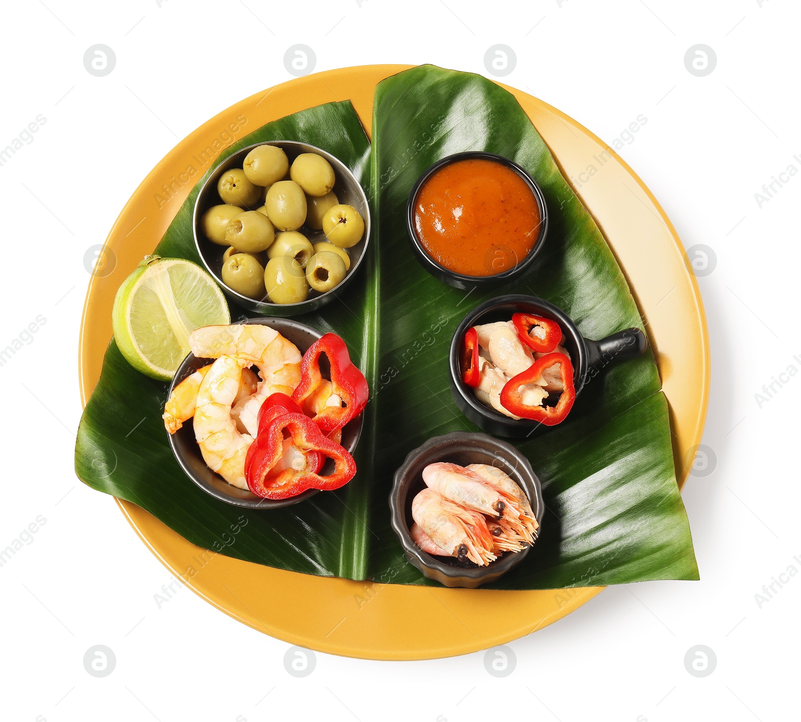 Photo of Cut banana leaf with different food and sauce isolated on white, top view. Healthy eco serving