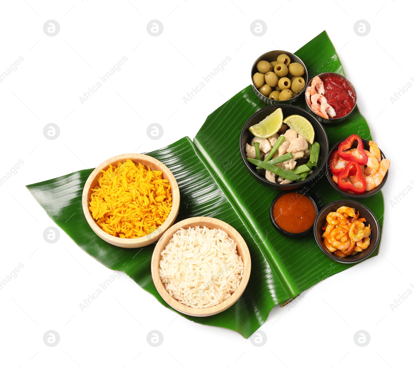 Photo of Piece of banana leaf with different food and sauce isolated on white, top view. Healthy eco serving