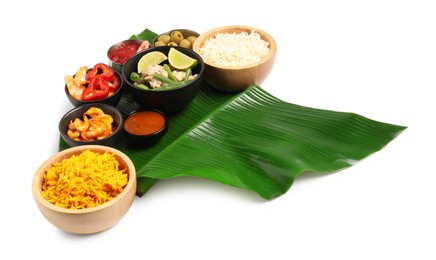 Photo of Piece of banana leaf with different food and sauce isolated on white. Healthy eco serving