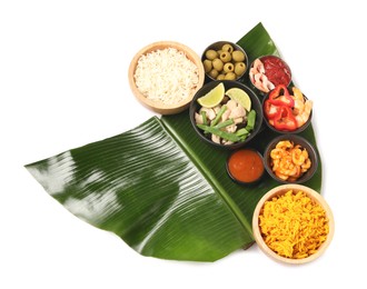 Photo of Piece of banana leaf with different food and sauce isolated on white, top view. Healthy eco serving