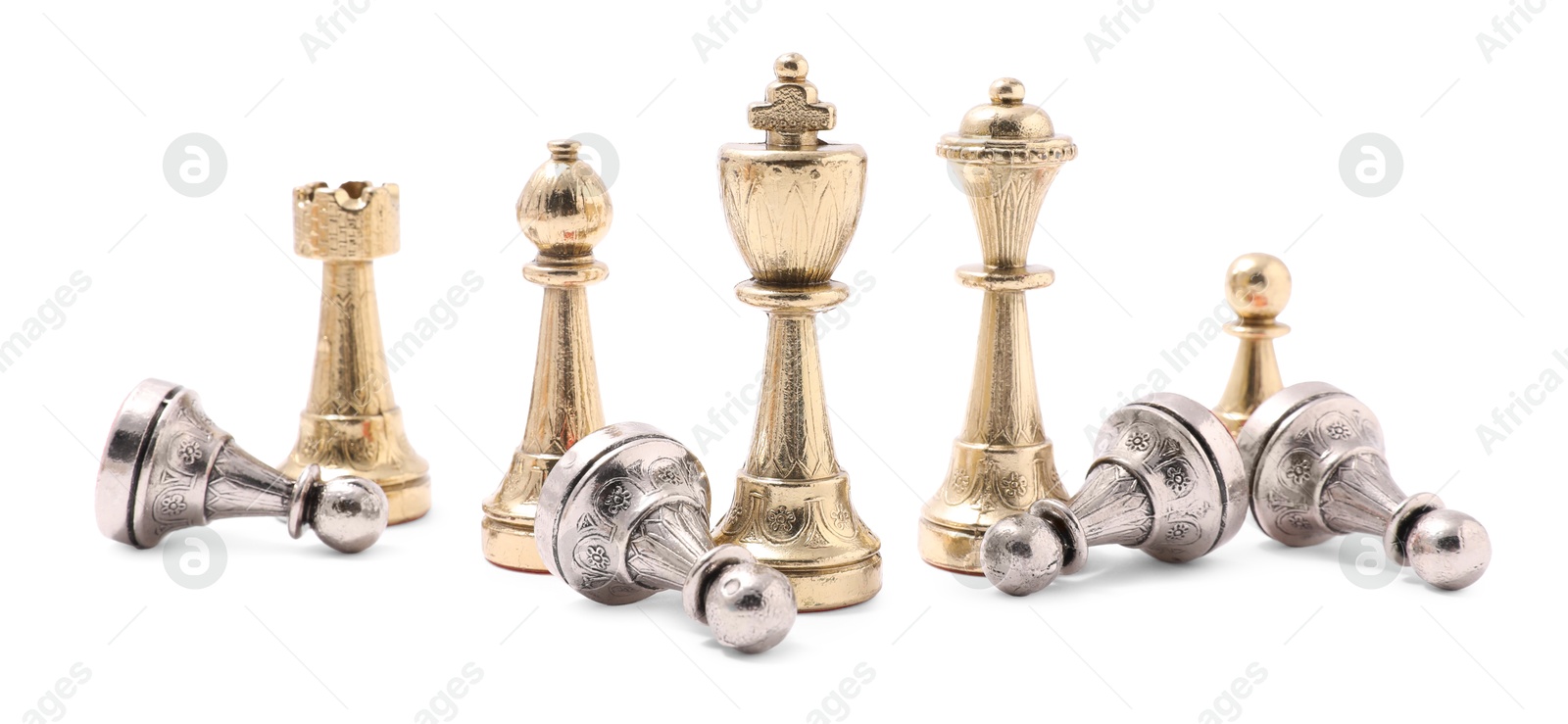 Photo of Golden chess pieces among fallen silver pawns on white background. Competition concept