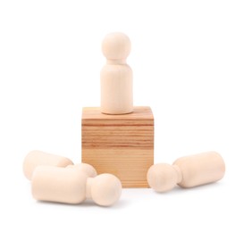 Photo of Pawn on wooden block near fallen ones against white background. Competition concept