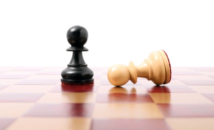 Photo of Pawn near fallen black one on wooden checkerboard against white background. Competition concept