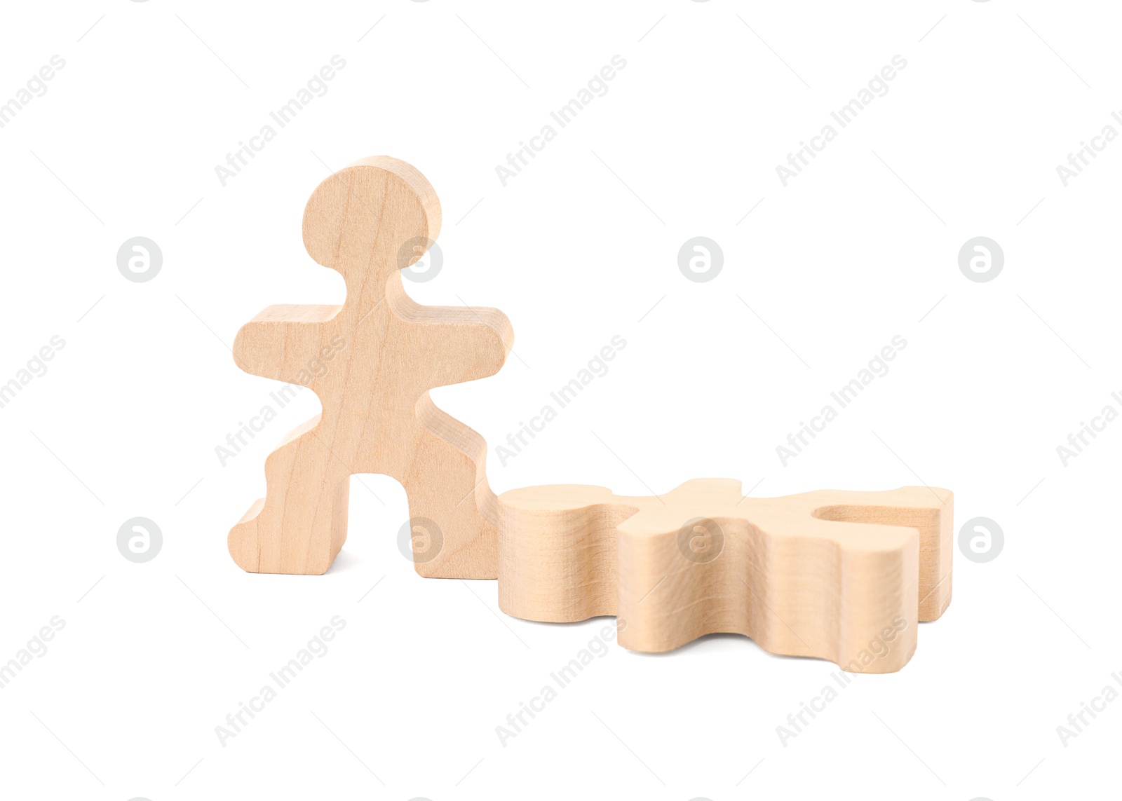 Photo of Wooden human figure near fallen one on white background. Competition concept