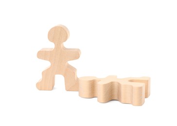 Photo of Wooden human figure near fallen one on white background. Competition concept