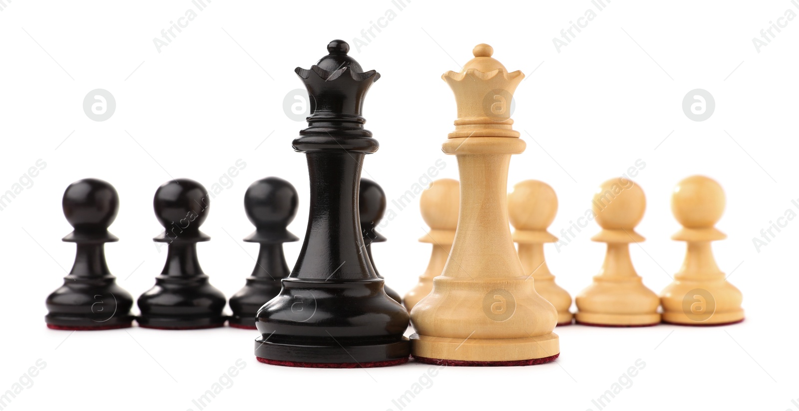 Photo of Black and white chess queens in front of pawns on white background. Competition concept