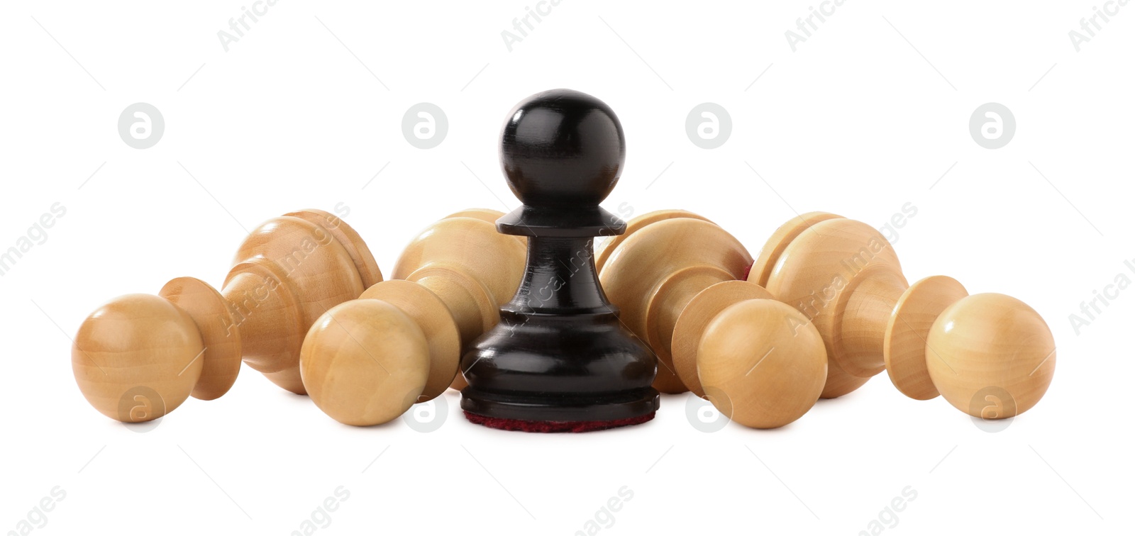 Photo of Black pawn among fallen white ones on white background. Competition concept