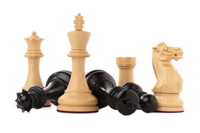 Photo of White chess pieces among fallen black ones on white background. Competition concept