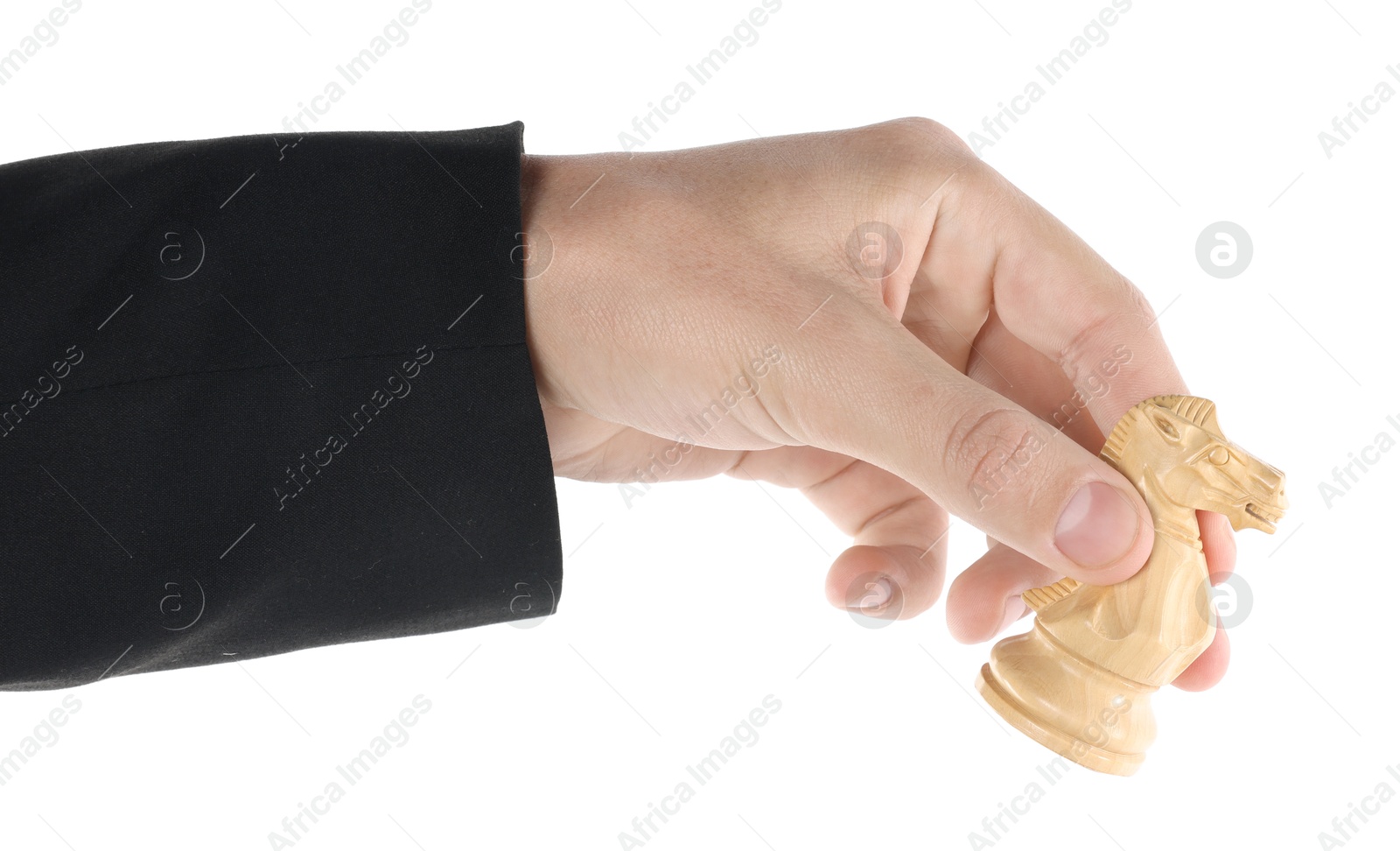 Photo of Man holding chess knight on white background, closeup. Competition concept