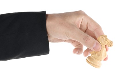 Photo of Man holding chess knight on white background, closeup. Competition concept