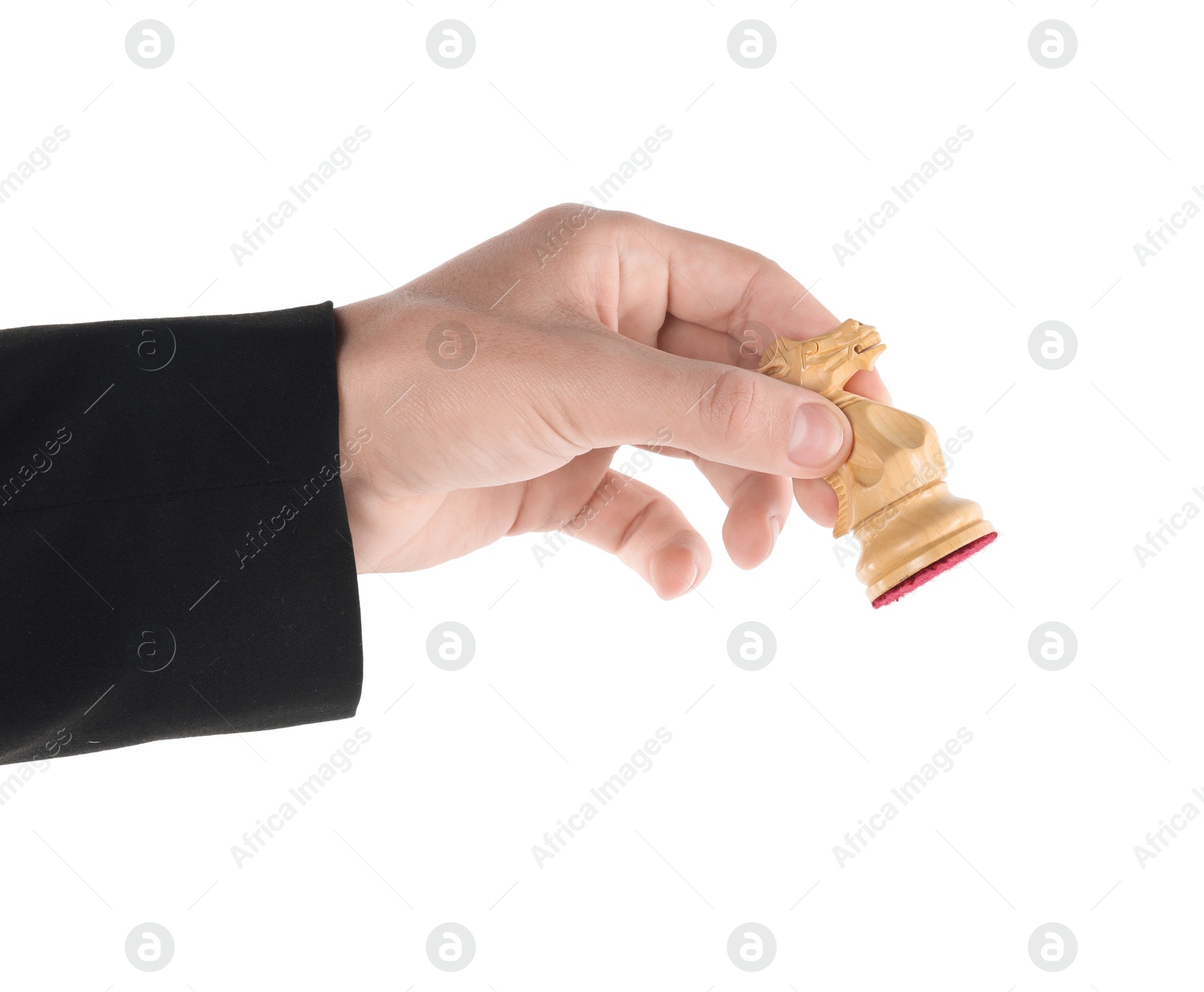 Photo of Man holding chess knight on white background, closeup. Competition concept