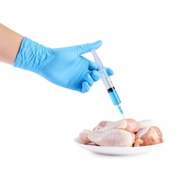 Photo of GMO concept. Scientist injecting something into chicken drumsticks on white background, closeup