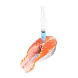 Photo of GMO concept. Piece of salmon and syringe isolated on white