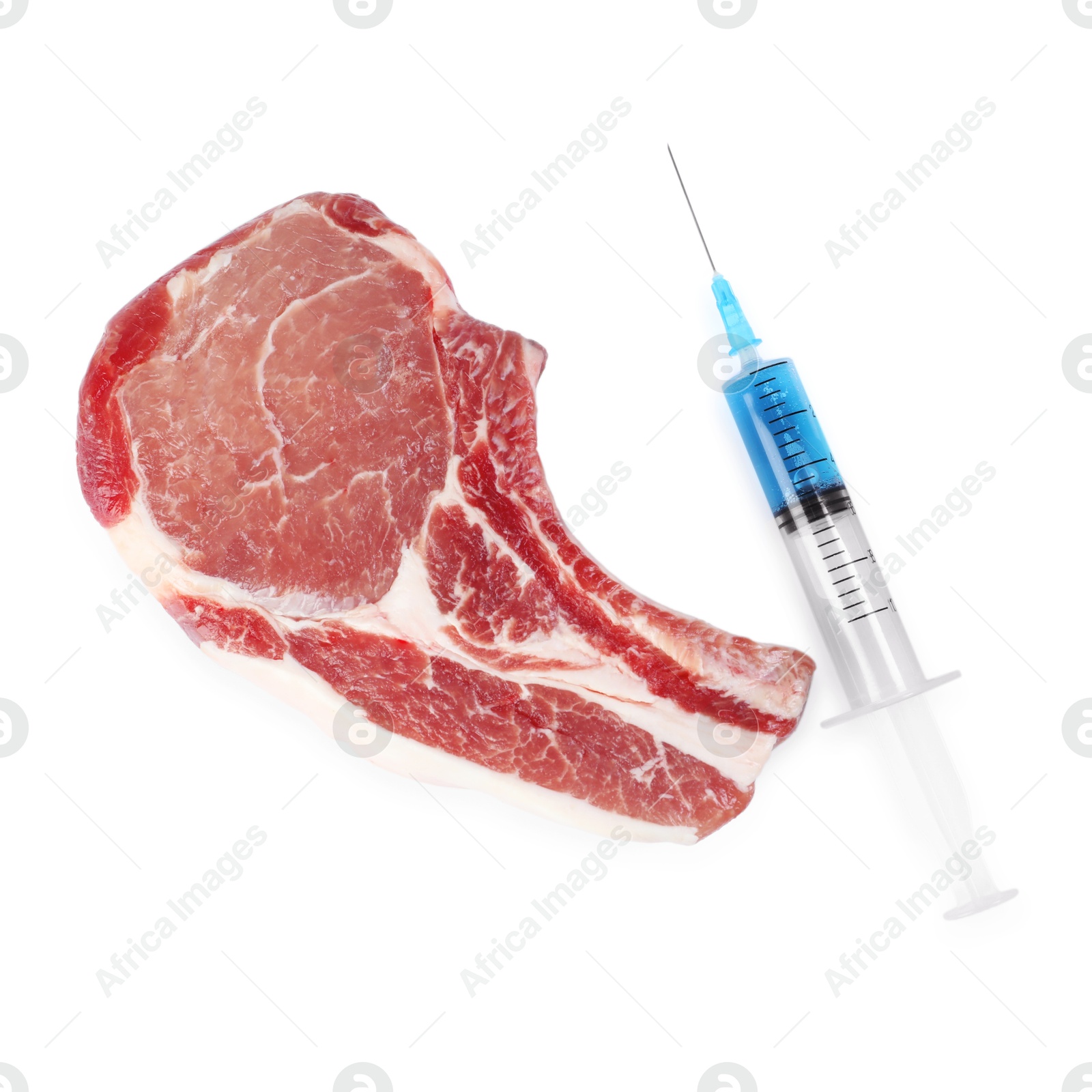 Photo of GMO concept. Pork steak and syringe isolated on white, top view