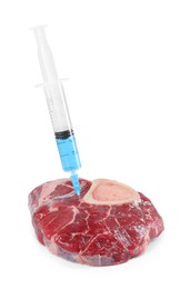 Photo of GMO concept. Piece of meat and syringe isolated on white