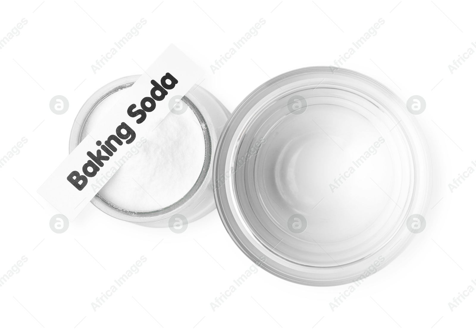 Photo of Glass of water and baking soda on white background, top view