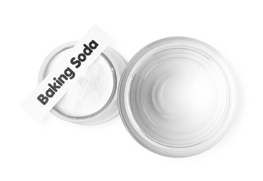 Glass of water and baking soda on white background, top view