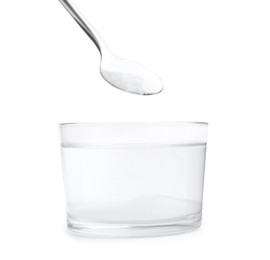 Photo of Adding baking soda to glass of water isolated on white, closeup