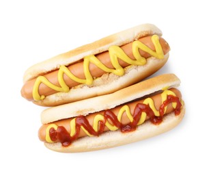 Photo of Tasty hot dogs with ketchup and mustard isolated on white, top view