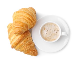 Photo of Tasty fresh croissants and cup of coffee isolated on white, top view. Puff pastry