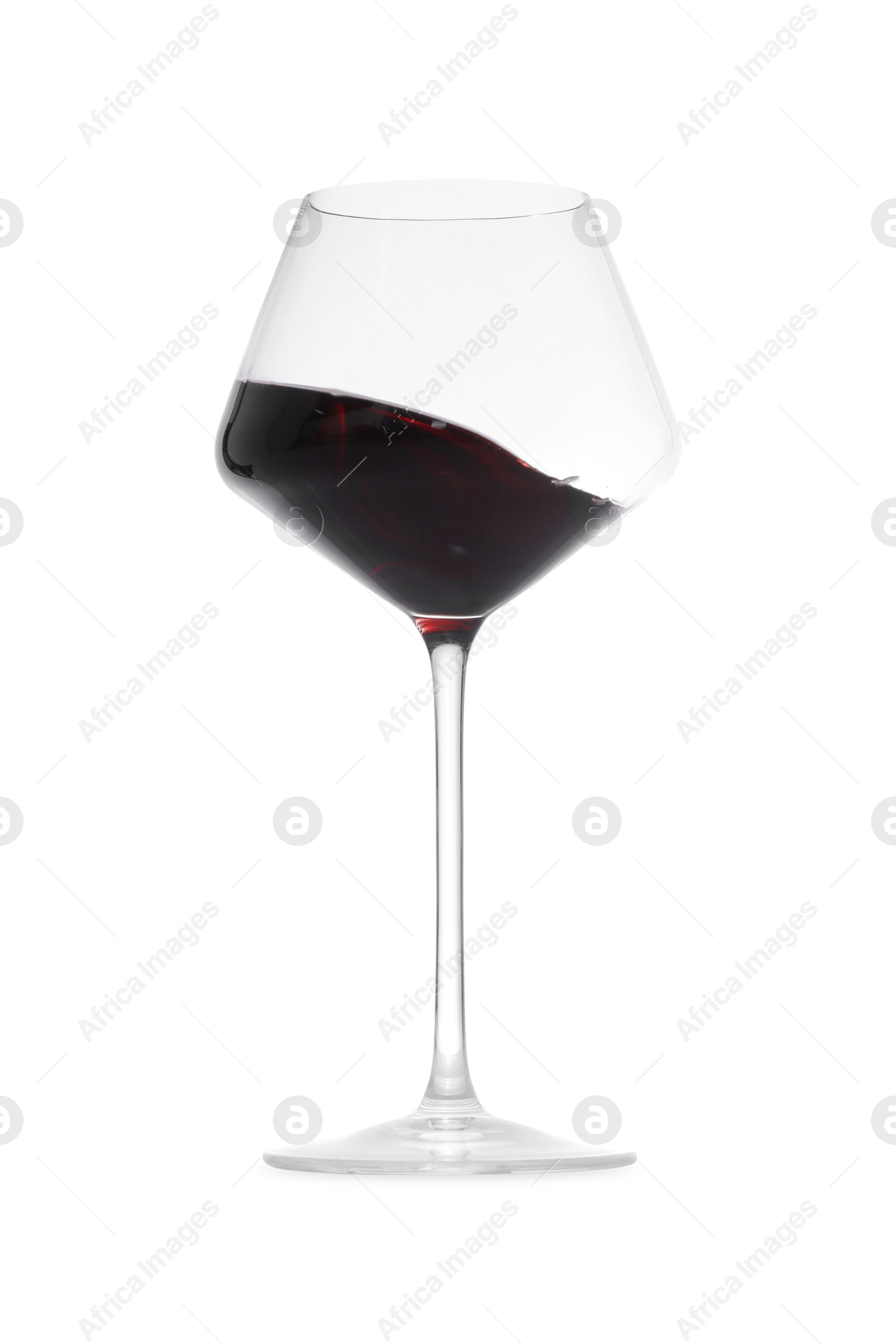 Photo of Red wine splashing in glass on white background