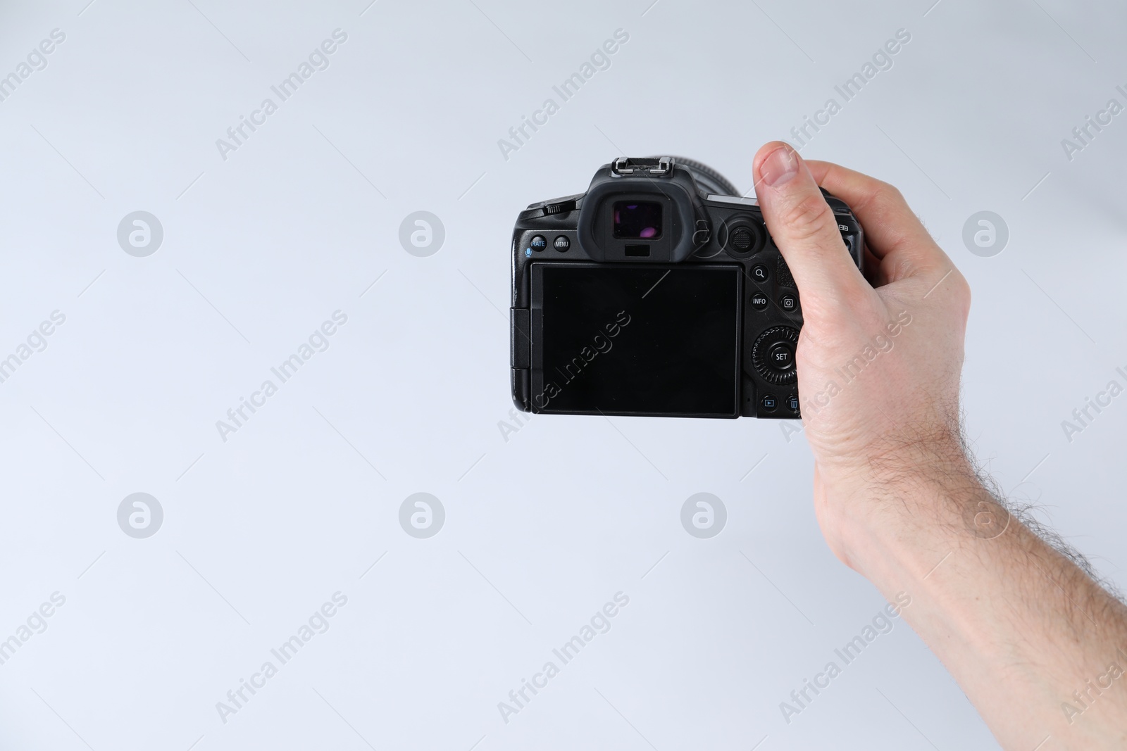 Photo of Photographer with professional camera on white background, closeup. Space for text