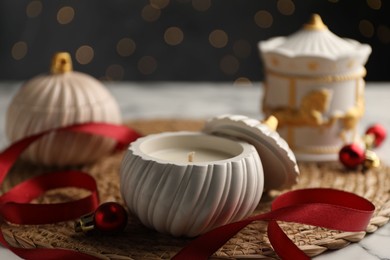 Soy wax candles on white table, closeup. Beautiful Christmas decor