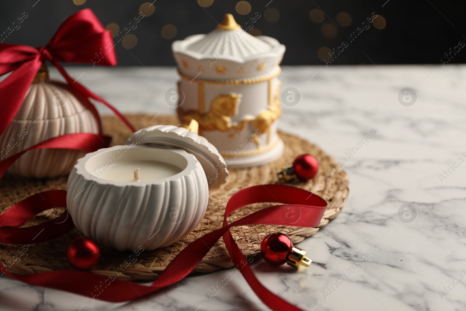 Photo of Soy wax candles on white marble table, closeup and space for text. Beautiful Christmas decor