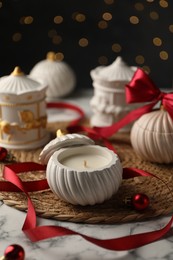 Photo of Soy wax candles on white marble table, closeup. Beautiful Christmas decor