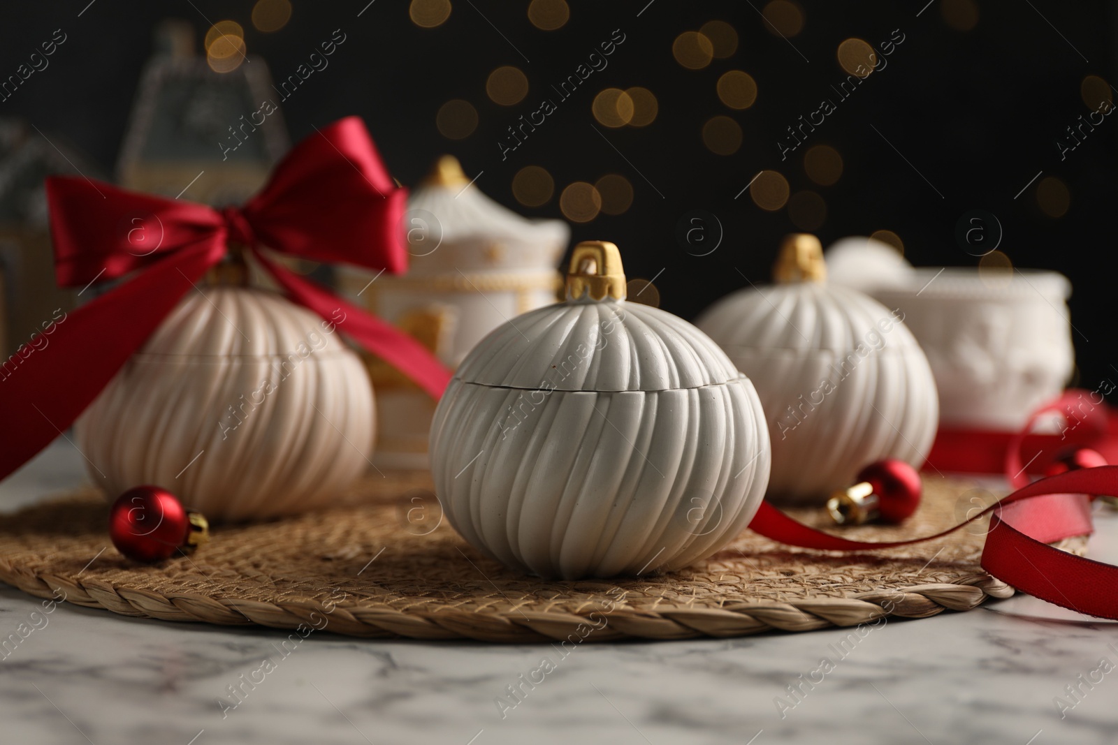 Photo of Soy wax candles on white marble table, closeup. Beautiful Christmas decor