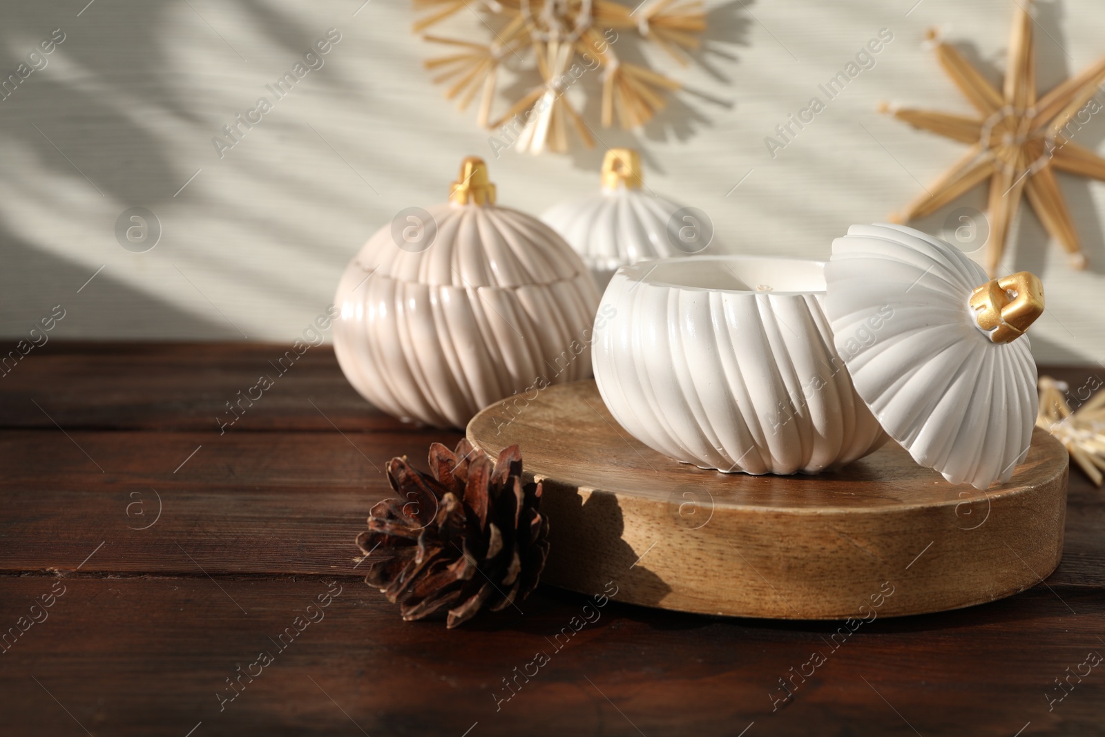 Photo of Soy wax candles and cones on wooden table, space for text. Beautiful christmas decor