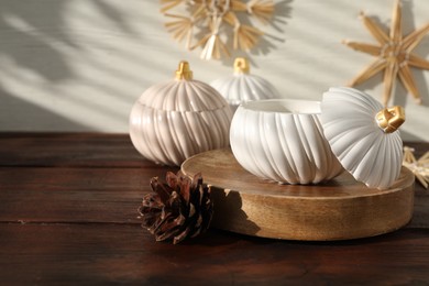 Photo of Soy wax candles and cones on wooden table, space for text. Beautiful christmas decor