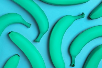 Image of Turquoise bananas on light blue background, flat lay