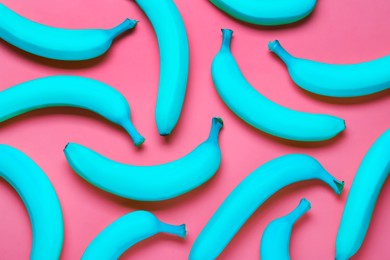 Image of Cyan color bananas on pink background, flat lay