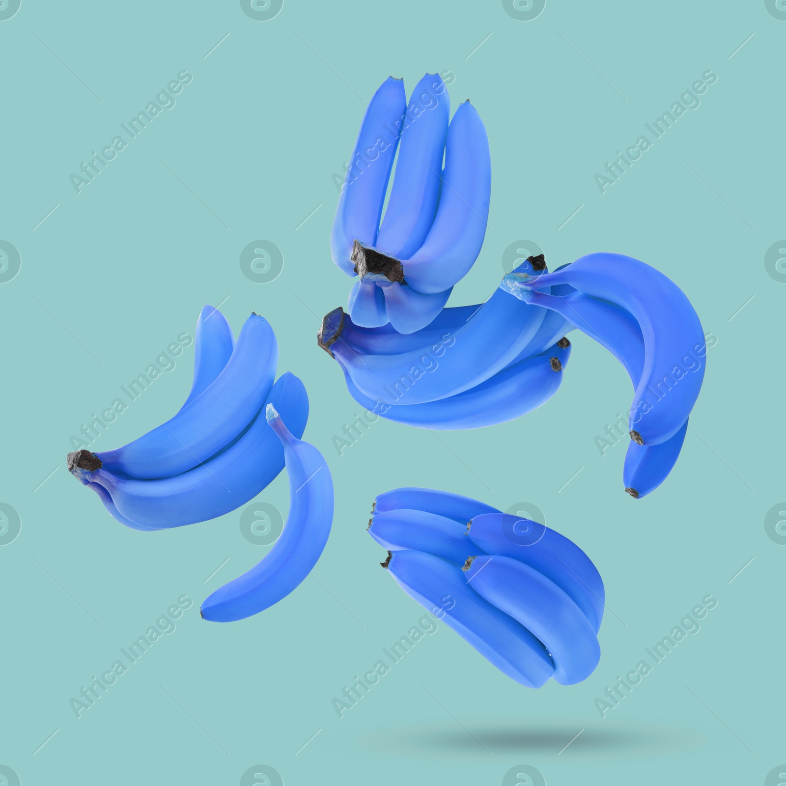 Image of Blue violet bananas in air on color background