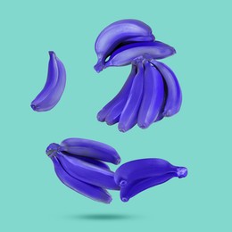 Image of Blue violet bananas in air on turquoise background