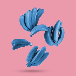 Image of Light blue bananas in air on pink background