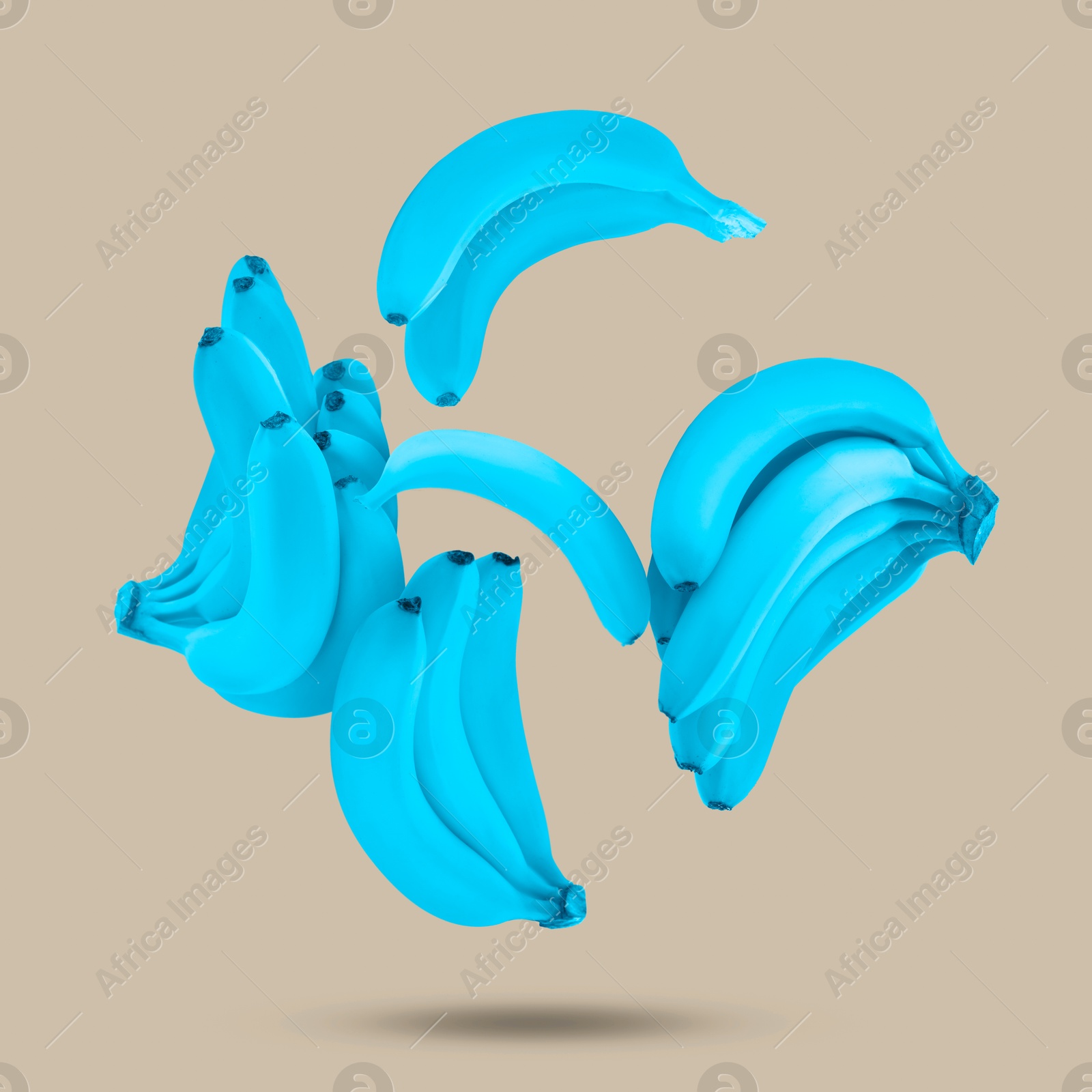 Image of Light blue bananas in air on beige grey background