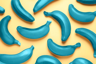 Image of Teal bananas on light orange background, top view