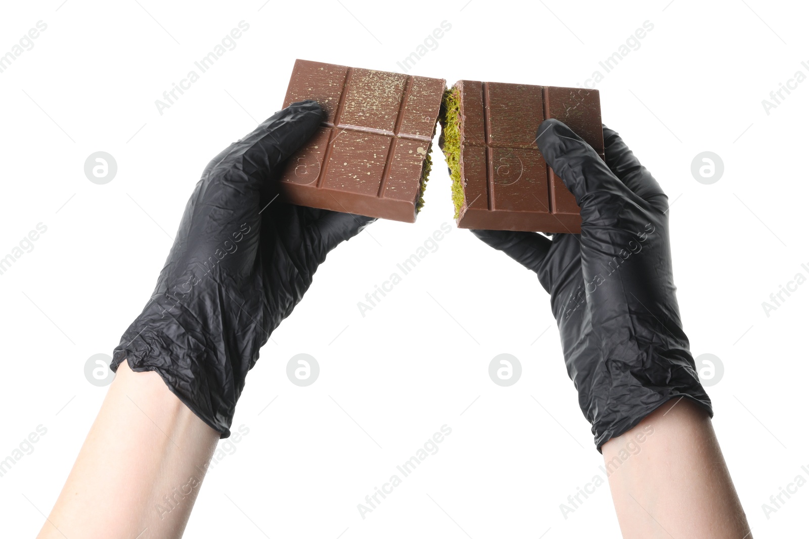 Photo of Woman holding pieces of tasty Dubai chocolate bar with pistachios and knafeh on white background, closeup