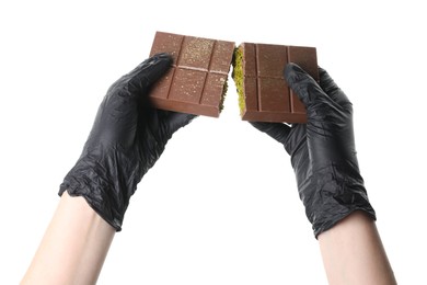 Photo of Woman holding pieces of tasty Dubai chocolate bar with pistachios and knafeh on white background, closeup