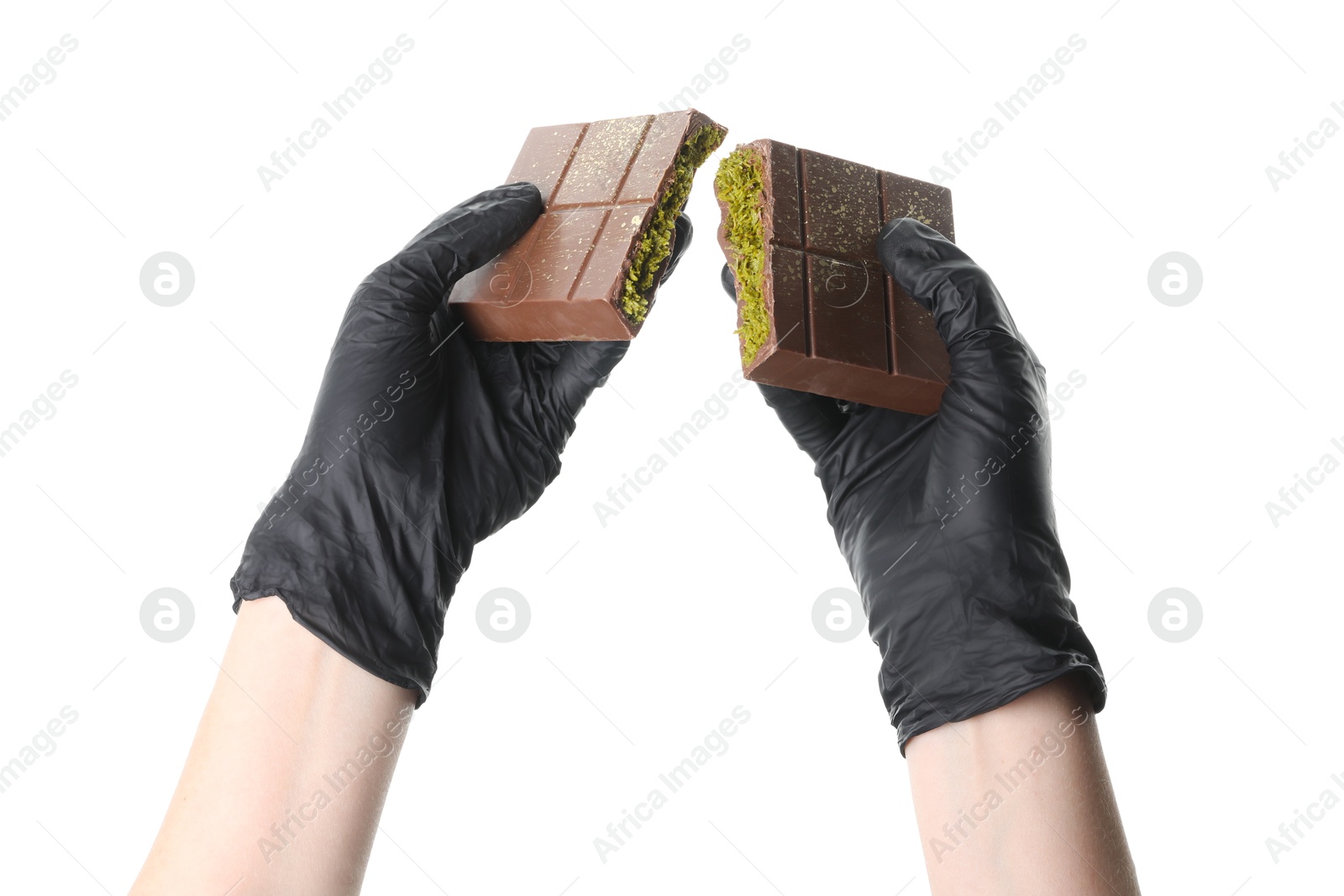 Photo of Woman holding pieces of tasty Dubai chocolate bar with pistachios and knafeh on white background, closeup